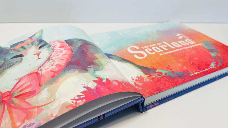 The Scarland Artbook laid flat on a white surface with a white background. It is open to two of the first pages. The pages showcase a beautiful Queen Jellie illustration by Julia Cocoabats, and the title text reads, "The Art of Scarland, A Community's Imag