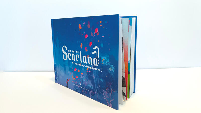 The Scarland Artbook on a white surface with a white background. It is stood such that the front and the open side of the book can be seen. The edges of the pages are barely visible since the book is cracked open.